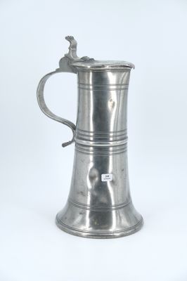 an antique silver plated tankard with a bird on the handle