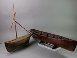 a small boat and a small boat on a stand
