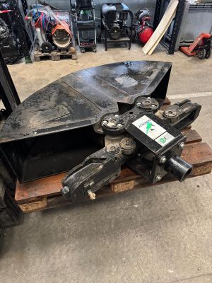 a close up of a fork attachment on a pallet in a garage
