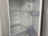 an open refrigerator with its door open in a kitchen