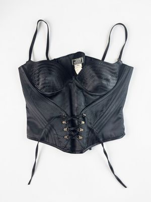 a black leather corset with laces on it