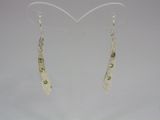 silver and peridot earrings on a white background