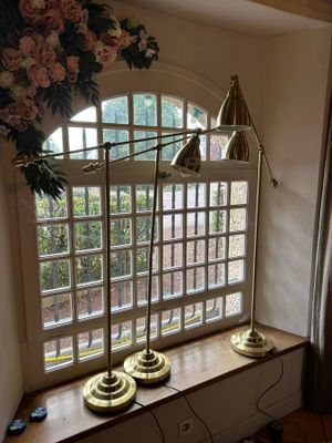two lamps that are sitting on a window sill