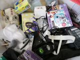 a pile of electronics and other items on a bed