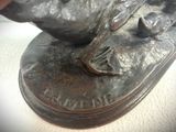 a close up of a bronze statue of a dog