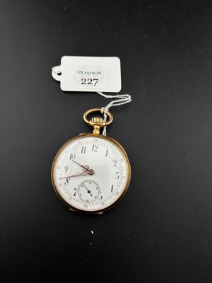 an old pocket watch with a tag attached to it on a black surface