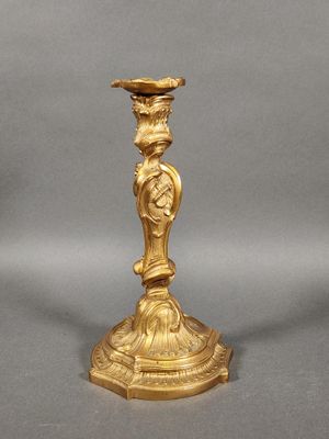 an image of a gold candle holder with a bird on top