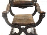 a wooden chair with a leather seat on a white background