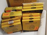 several boxes of adhesive foam sitting on top of a white counter