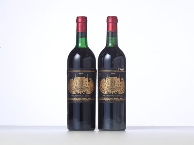 two bottles of red wine sitting on top of a table