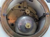 a close up of a clock with a metal ball inside of it