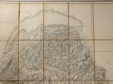 an old map of a mountain range on a tile wall