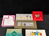 lot of assorted boxed perfumes including a perfume bottle, perfume box, and a perfume brush