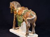 a statue of a horse with a saddle on it ' s back