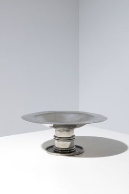 an image of a silver plate sitting on top of a white table