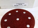 a close up of a sanded disc on a table with a box in the background