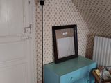 a room with a blue dresser and a mirror on the wall