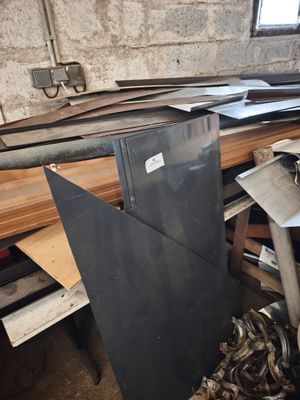 several pieces of metal are stacked on top of each other in a room
