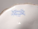 an image of a close up of a white vase with a blue seal on it