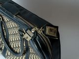 a black and beige purse with a zipper on it