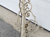 a white metal pole with a clock on top of it
