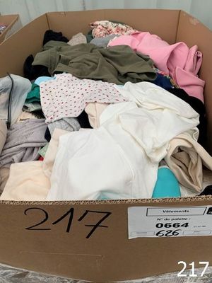 a cardboard box full of clothes that is on display