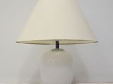 a white lamp that is sitting on a table