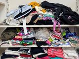 a closet with a lot of clothes on the shelves