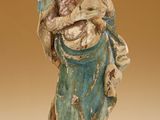 an old statue of a woman holding a child in her arms