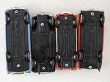 four toy cars that are lined up in a row