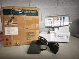 an image of a sewing machine with a box and power cord