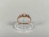 a close up of a gold ring on a clear surface