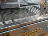 a close up of a coffee machine on a wooden table