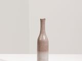 a brown vase sitting on a white table