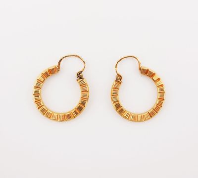 a pair of gold hoop earrings on a white background