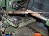a machine that is working on a piece of wood