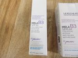 two bottles of melab b3 serum sitting on a wooden table