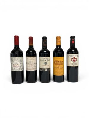 four bottles of wine are lined up on a white surface
