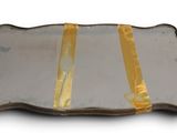 a glass tray with a gold ribbon on it