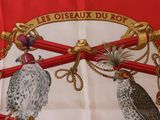 two birds that are sitting on top of a red object