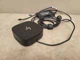 a small black box sitting on the floor next to a charger
