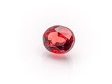 a close up of a red diamond on a white surface