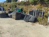 a pile of tires sitting on the side of the road