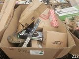 a cardboard box full of assorted items in a pile
