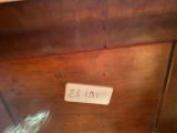a sign on the side of a wooden cabinet