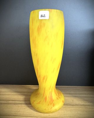 a yellow vase that is sitting on a table