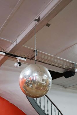a disco ball hanging from the ceiling of a building