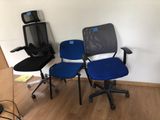 three office chairs in the corner of a room
