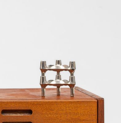a close up of a wooden cabinet with two candles on top