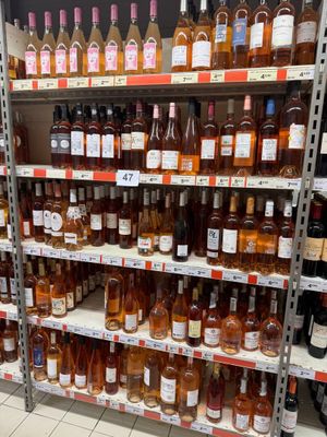 bottles of wine are on a shelf in a liquor store